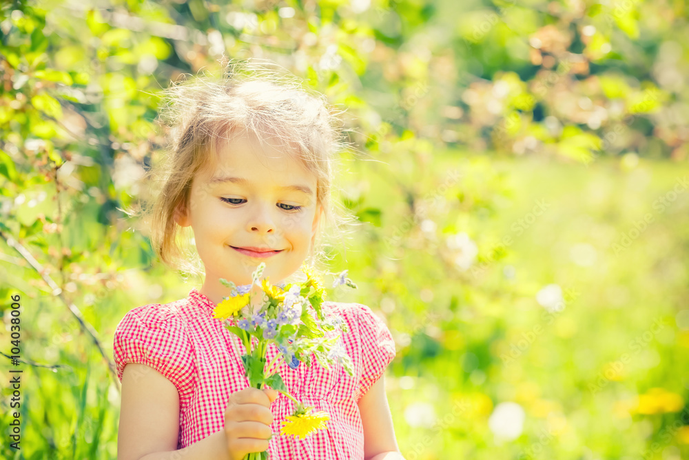 Happy little girl playing with bouquet in sunny park Happy little girl playing with bouquet in sunny park