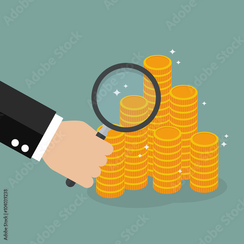 Hand holding magnifying glass with money