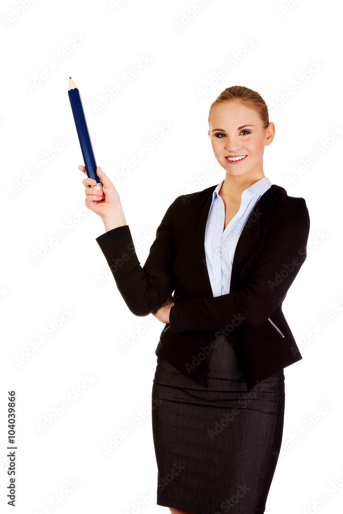 Business woman pointing for copyspace or something with huge pen Business woman pointing for copyspace or something with huge pen