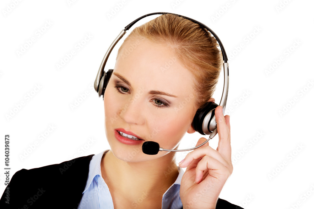 Young woman helpline operator is trying to hear something headphones Young woman helpline operator is trying to hear something headphones