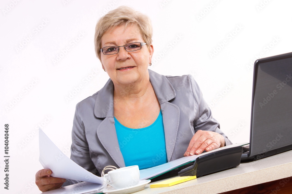 Elderly business woman working with documents at desk in office, business concept Elderly business woman working with documents at desk in office, business concept