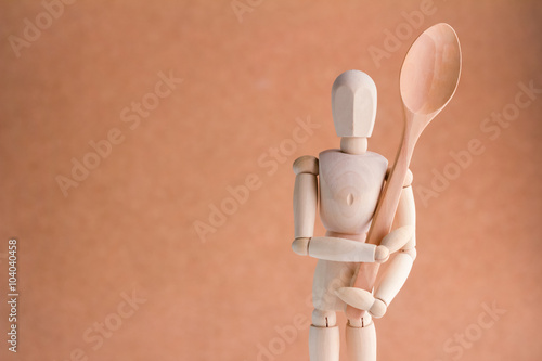 wooden Man holding wooden utensils