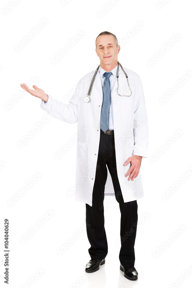 Male doctor holding copyspace in right hand Male doctor holding copyspace in right hand