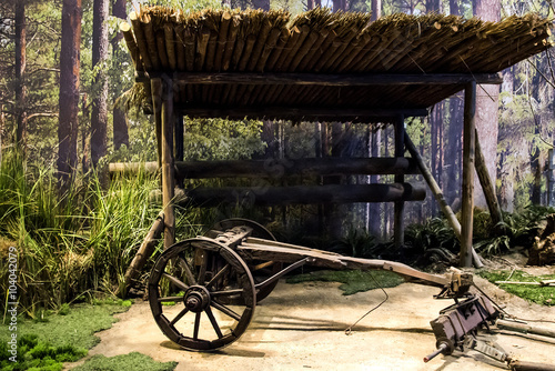 Old wooden coach wheel near barn in the village photo