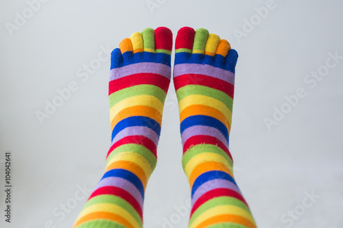 Close-up photo woman's feet in multi color socks