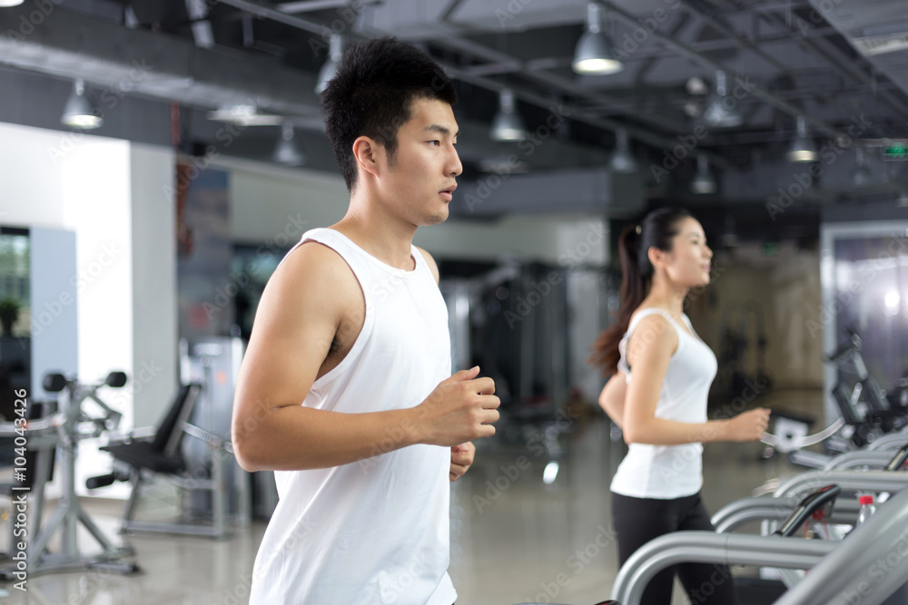 young people working out in modern gym young people working out in modern gym