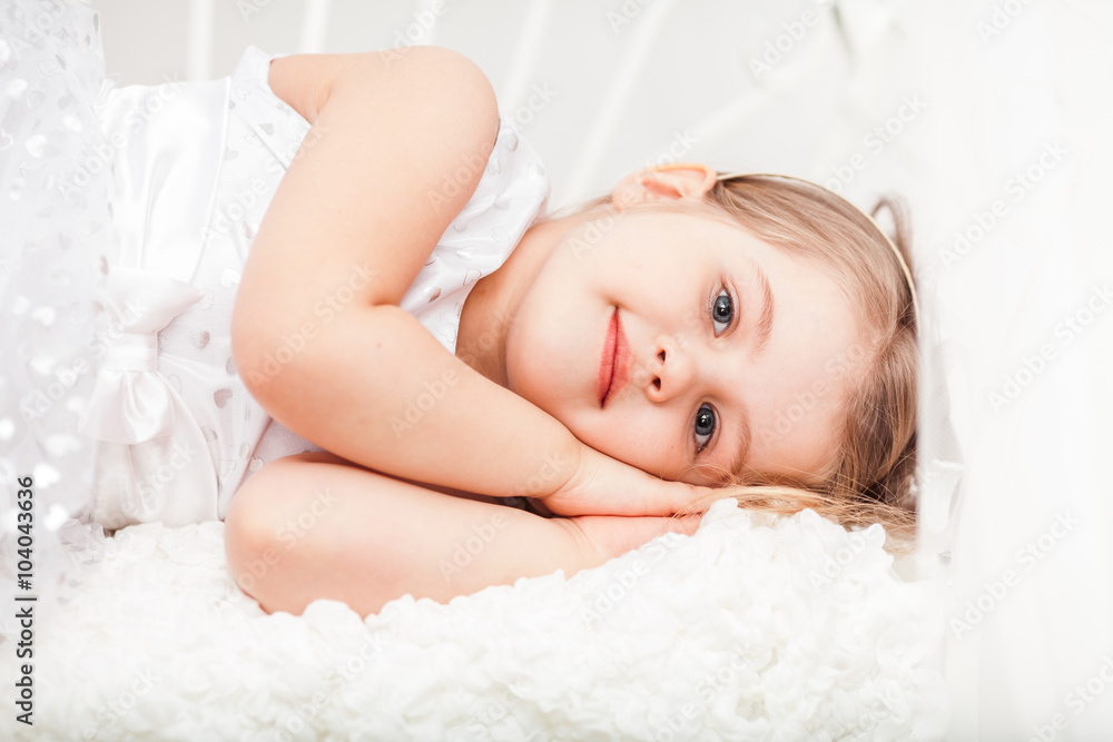 Cute little girl in white pretending sleep Cute little girl in white pretending sleep