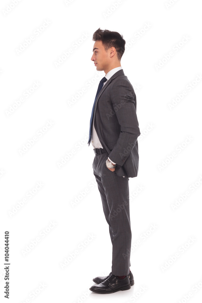 side view of a young business man standing in line side view of a young business man standing in line