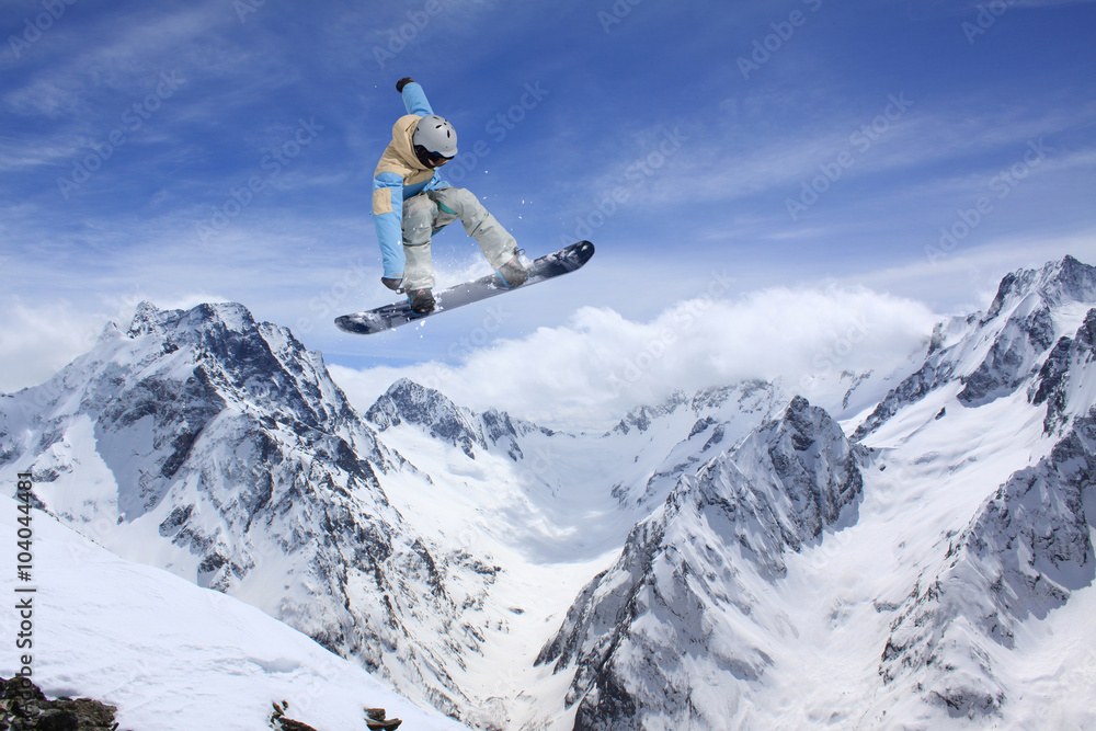 Flying snowboarder on mountains. Extreme sport. Flying snowboarder on mountains. Extreme sport.