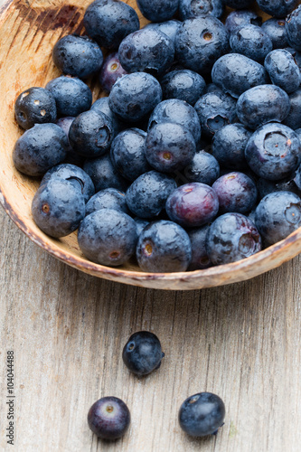 Blueberries in a bowl on a wooden table.