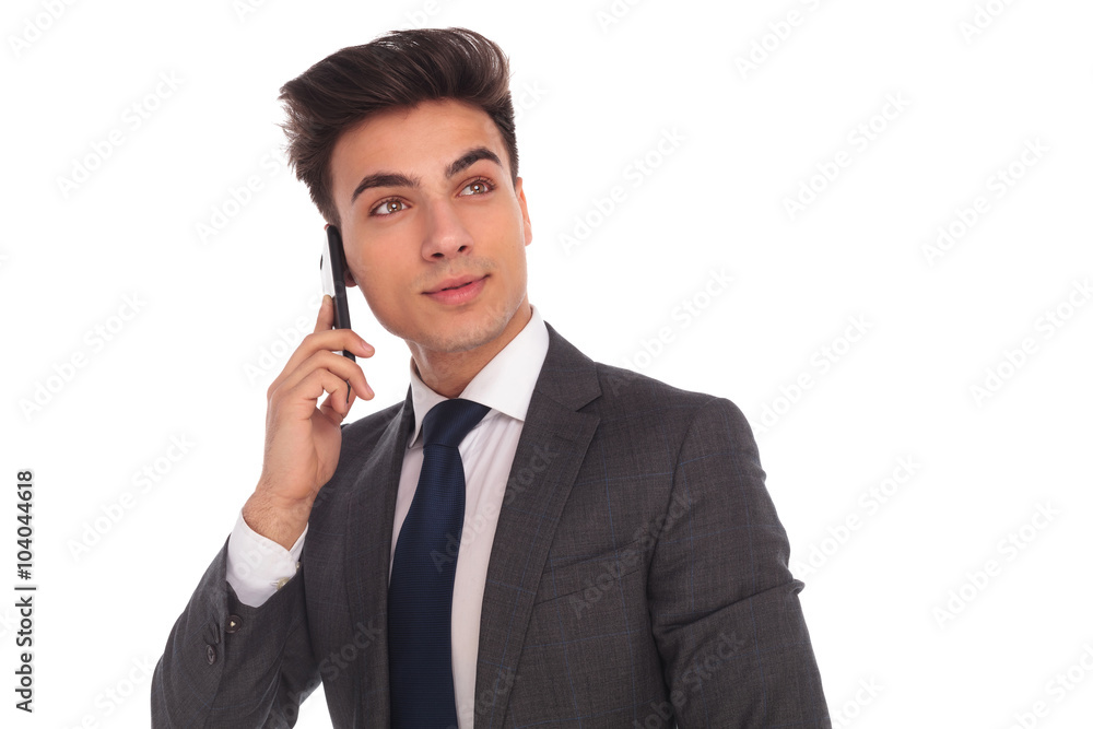 business man talking on the phone and looking up business man talking on the phone and looking up