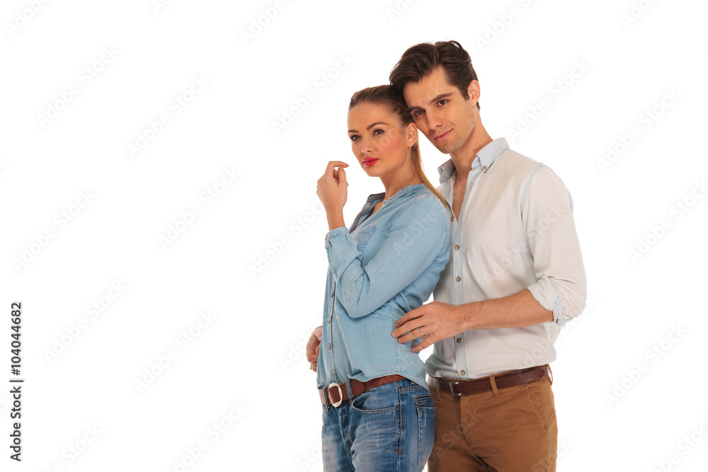smiling couple posing embraced in isolated studio smiling couple posing embraced in isolated studio