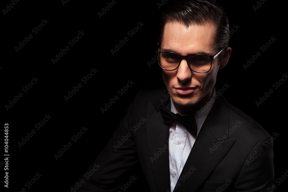 smart businessman in black suit posing in dark studio smart businessman in black suit posing in dark studio