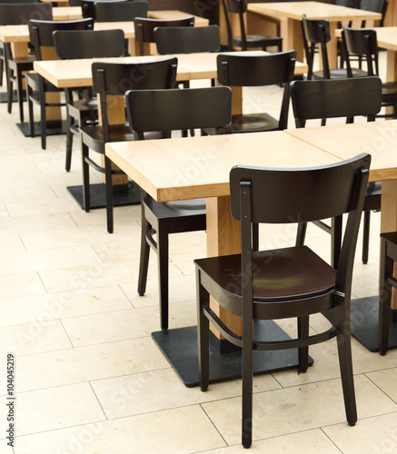 Restaurant furniture. Empty dining hall  fast food restaurant or canteen. Indoor shot with no people.