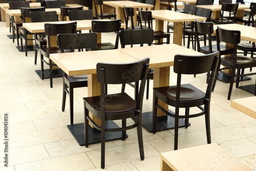Restaurant furniture. Empty dining hall  fast food restaurant or canteen. Indoor shot with no people.