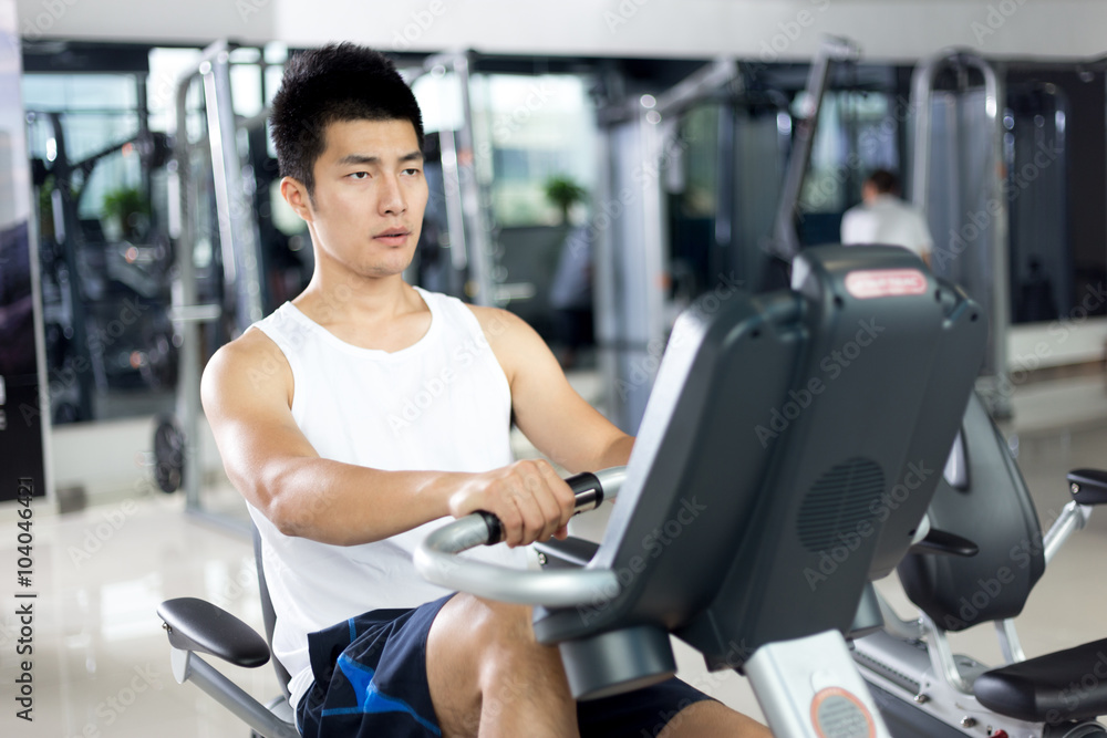 young handsome man working out in modern gym
