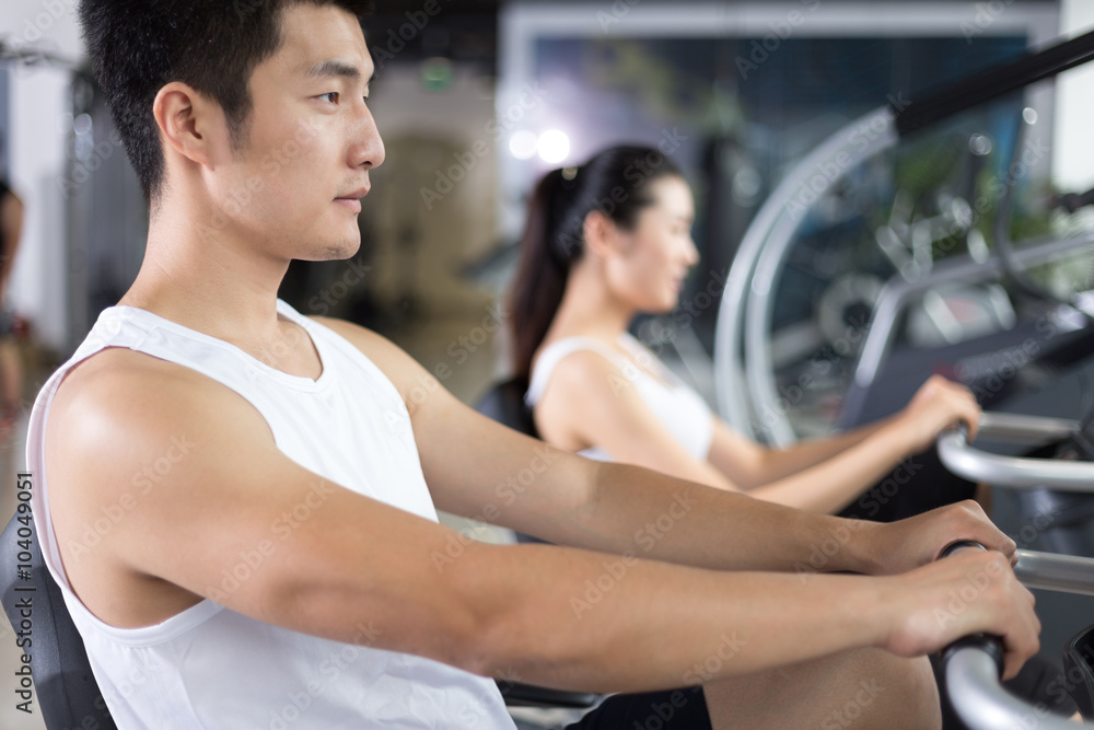 young people working out in modern gym young people working out in modern gym