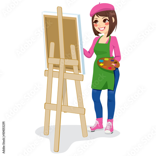 Beautiful painter artist woman holding palette and painting on canvas on easel