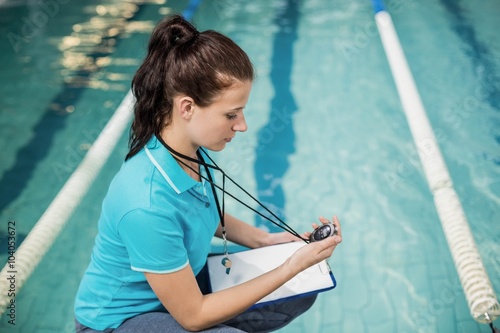 Trainer woman holding a stopwatch photo