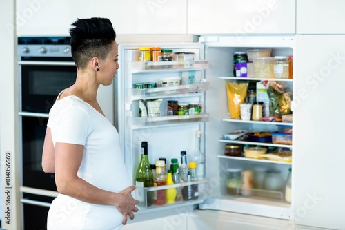 Pregnant woman looking in the fridge