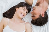 young couple lying on bed