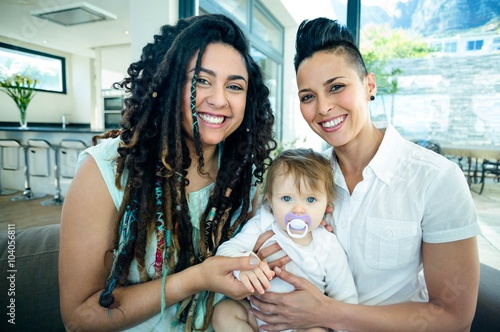 Portrait of lesbian couple with their baby