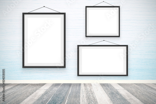 Blank picture frames on the wooden wall room  