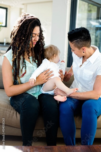 Lesbian couple playing with their baby