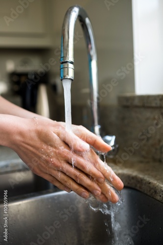 Pretty woman washing her hands