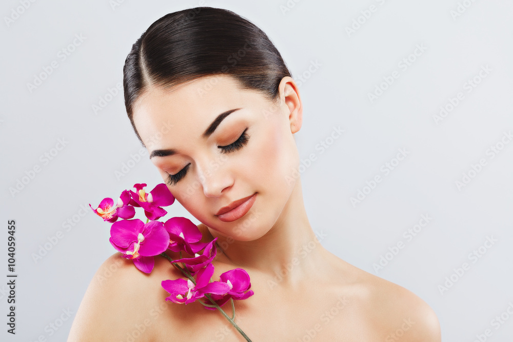 Gorgeous girl wearing white rowel and holding flower Gorgeous girl wearing white rowel and holding flower