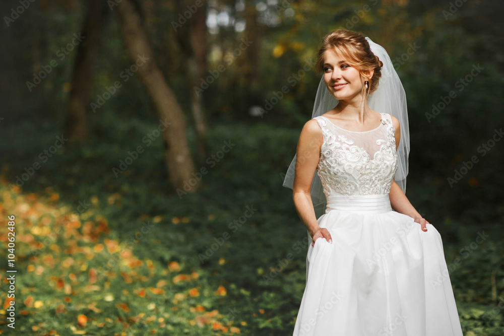 luxury stylish young bride on the background  spring sunny green