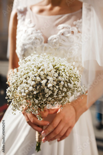 cute stylish unusual wedding bouquet of flowers on the backgrou