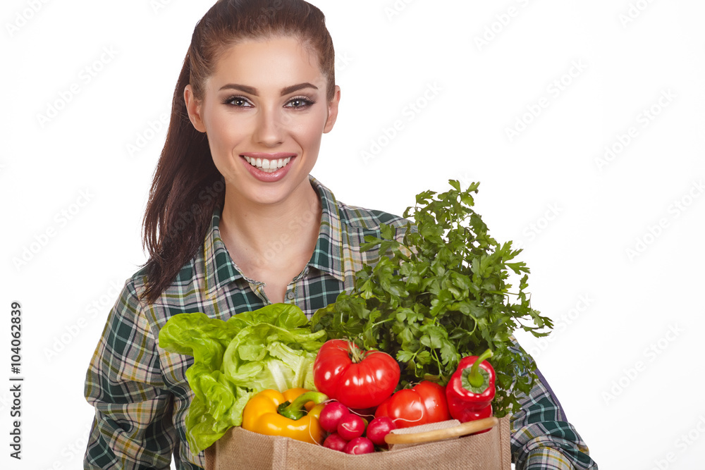 Isolated woman holding a shopping bag full of vegetables Isolated woman holding a shopping bag full of vegetables