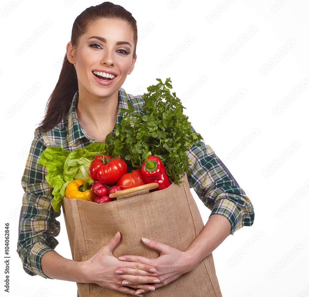 Isolated woman holding a shopping bag full of vegetables Isolated woman holding a shopping bag full of vegetables