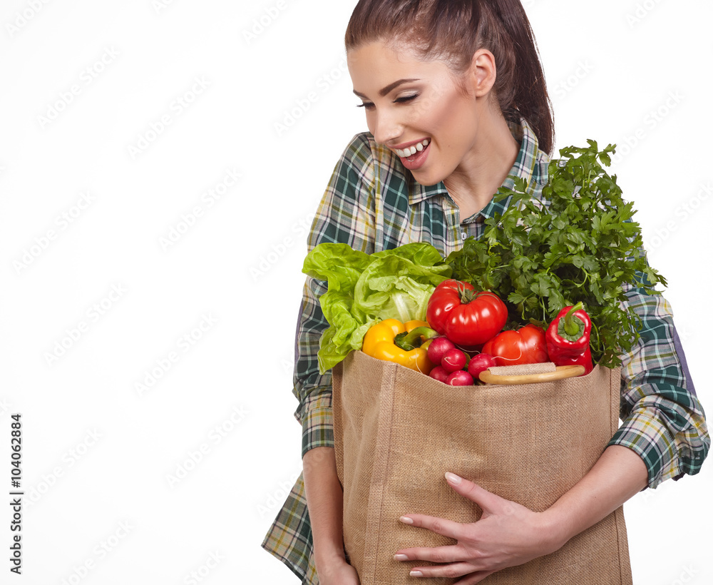 Isolated woman holding a shopping bag full of vegetables Isolated woman holding a shopping bag full of vegetables