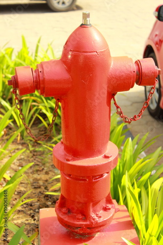 Red fire hydrant in the grass in the courtyard of an office