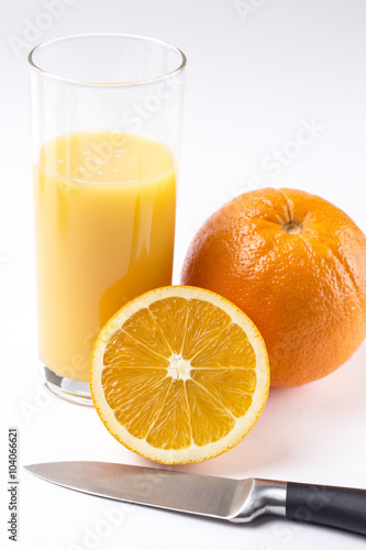 Fresh orange juice in glass with sliced orange