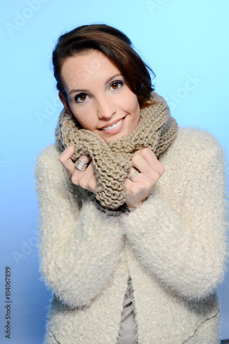 fashion studio portrait of a pretty young woman in winter outfit