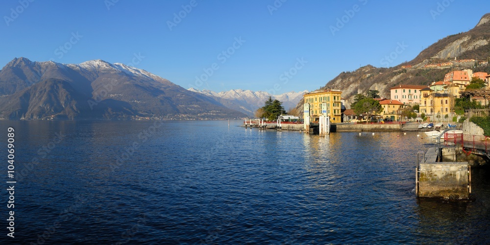 View of the lake and mountains above it. The small old resort town Varenna on the shore of the lake Como  in the Province of Sondrio in the Italian region Lombardy.