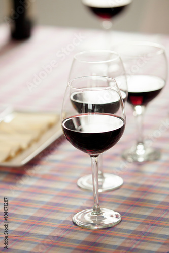 Glasses of red wine and cheese tray
