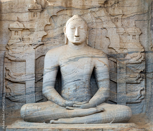 Buddha statue carved in to the rock photo