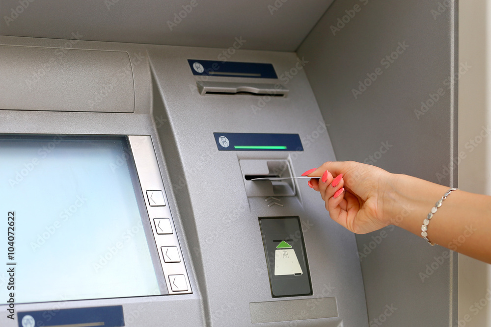 woman hand inserting credit card to ATM woman hand inserting credit card to ATM