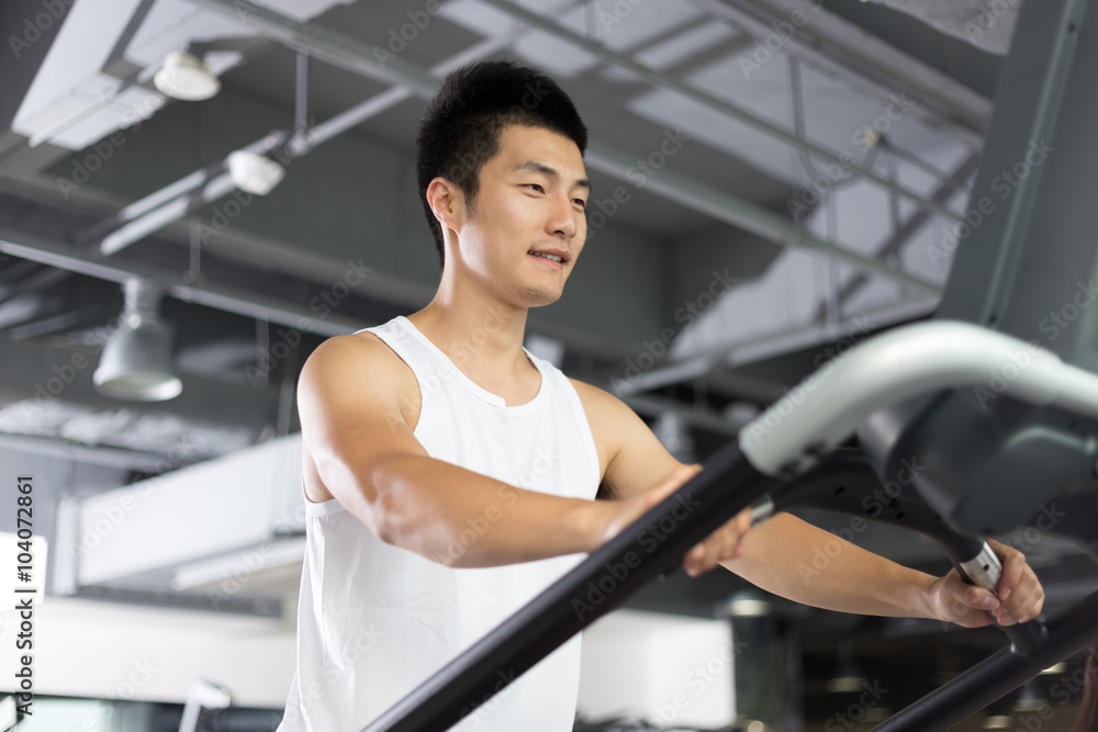 young man working out in modern gym young man working out in modern gym