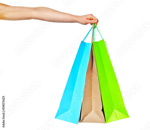 Closeup of womans hand with shopping bags.