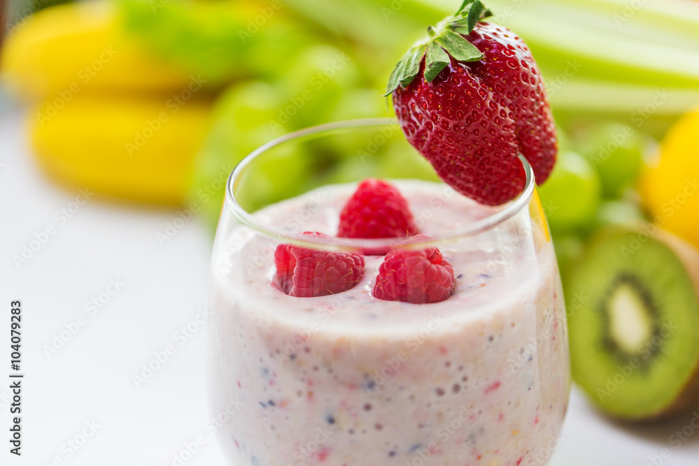 close up of glass with milk shake and fruits