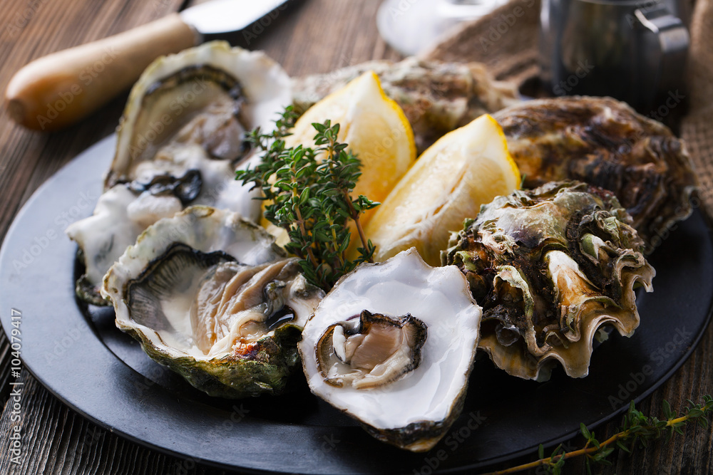Fresh Oysters in shell with lemon Fresh Oysters in shell with lemon