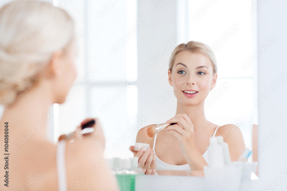 woman with makeup brush and powder at bathroom woman with makeup brush and powder at bathroom