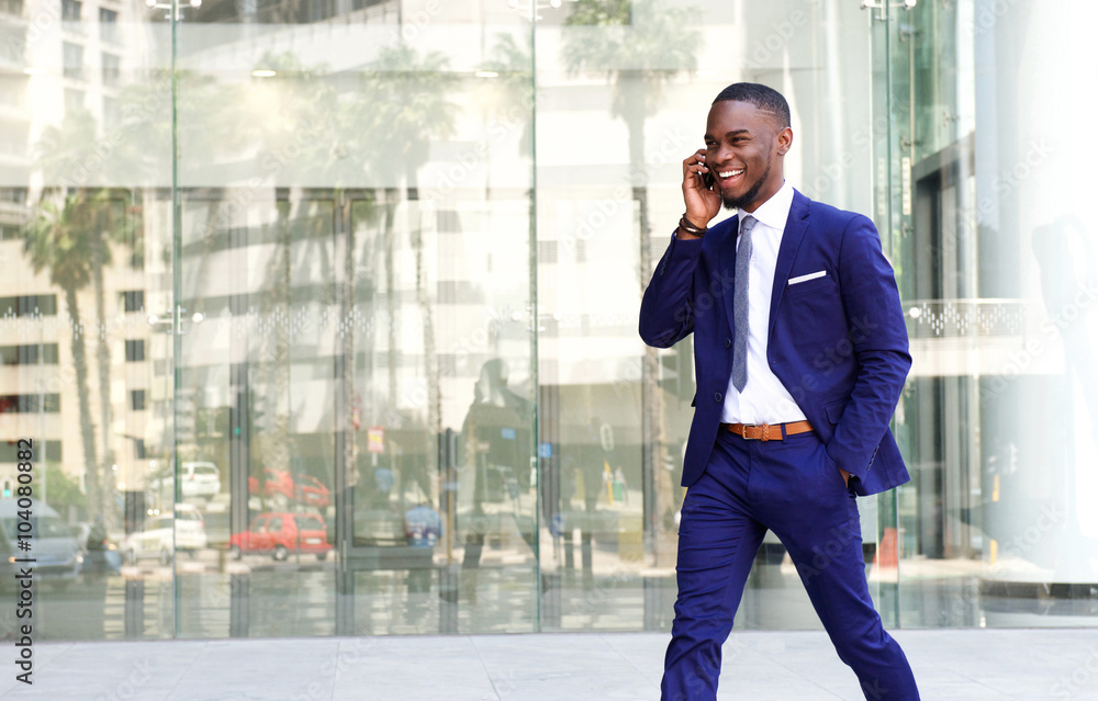Friendly african businessman talking on mobile phone Friendly african businessman talking on mobile phone
