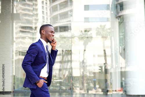 Young african businessman talking on cell phone