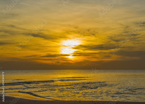 Sun sets over horizon of ocean. Sky, water and shore in the even © Aaom50